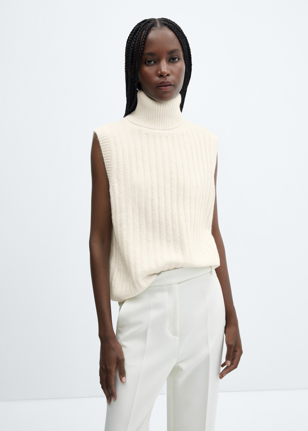 sleeveless cream turtleneck